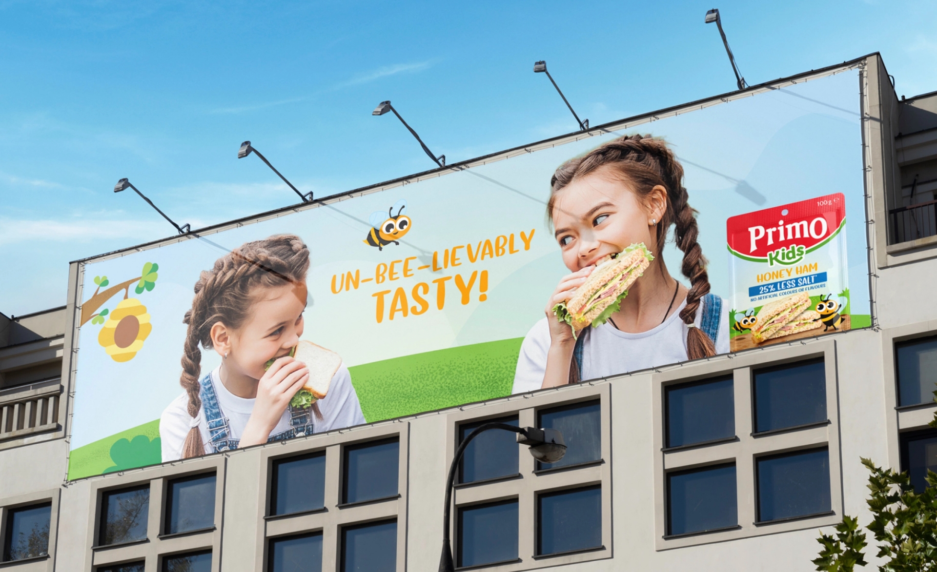 Billboard Primo advert design featuring slogan “un-bee-lievably tasty!” next to a child eating a sandwich and a cartoon illustration of a bee.