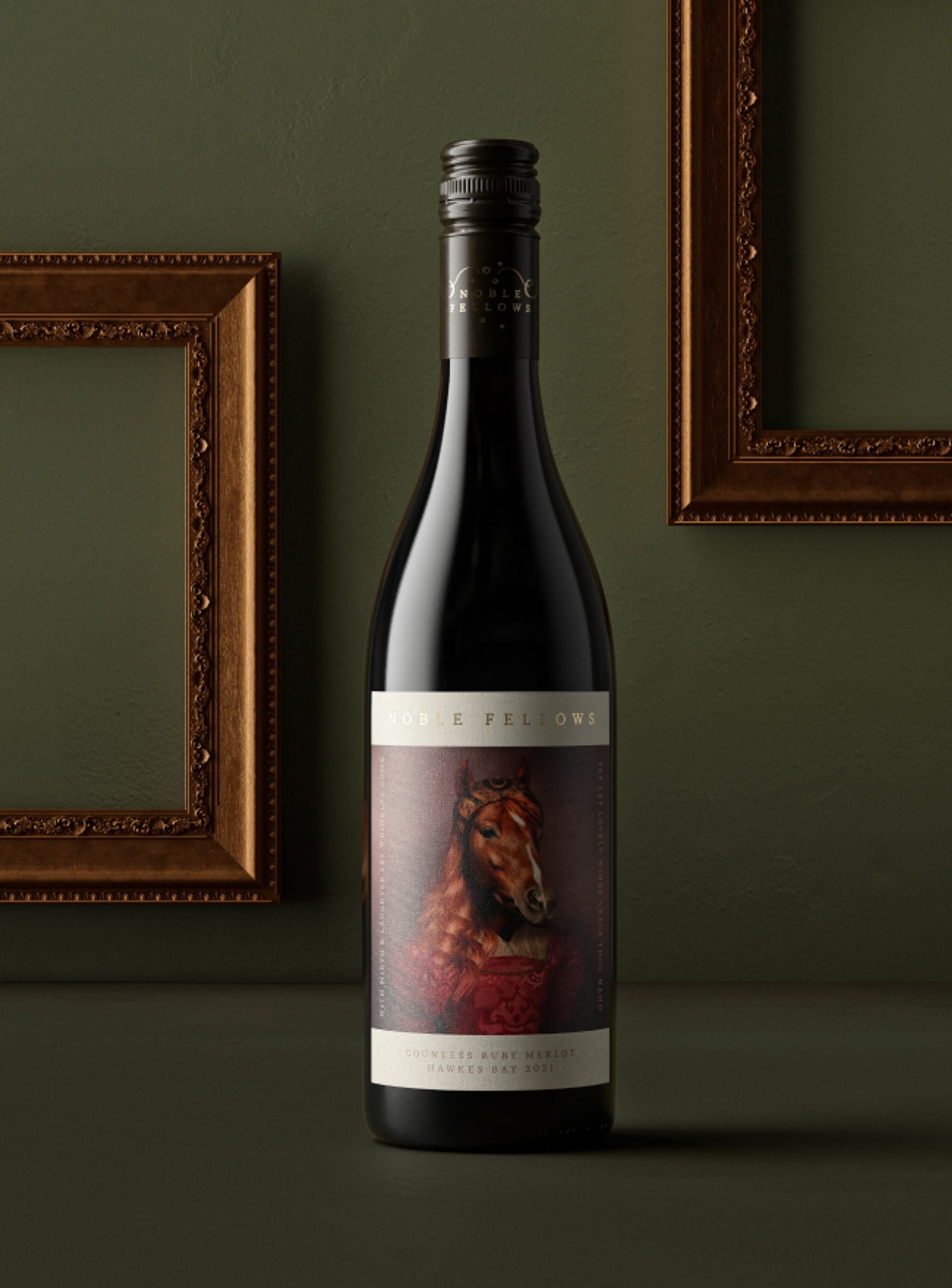Wine label design on wine bottle of Noble Fellows “Countess Ruby Merlot”, wine packaging design by Our Revolution in Sydney in front of two embellished copper frames on a dark green wall