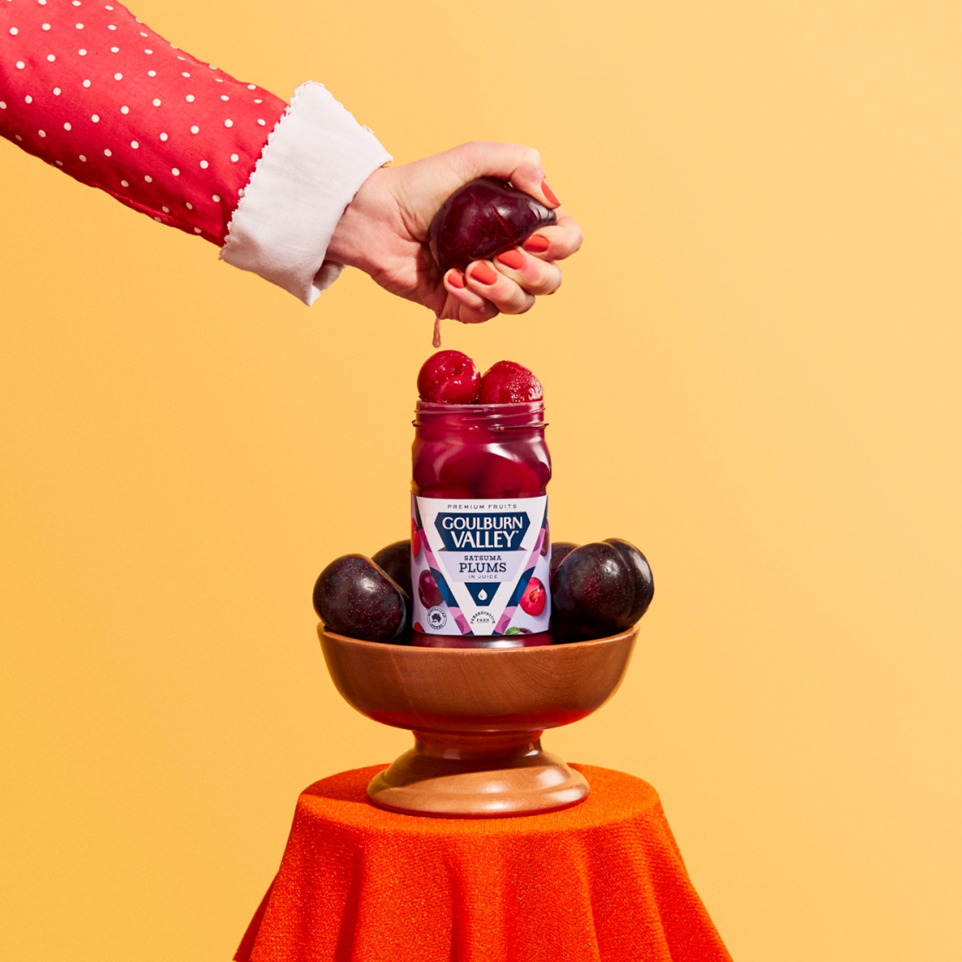 Hand squeezing fresh fruit into Goulburn Valley fruit jar, rebrand design by Sydney packaging design agency Our Revolution