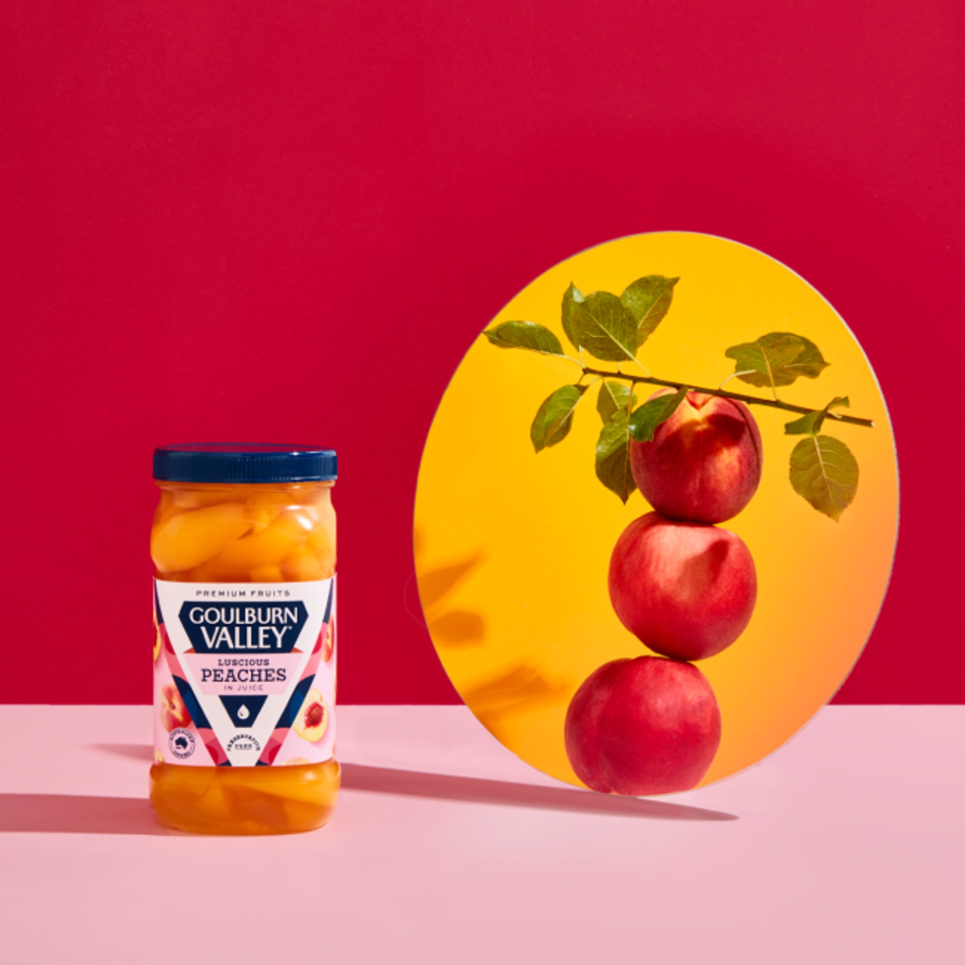 Bright fruit packaging design for Goulburn Valley rebrand with bold red background and mirror view of ripe fresh peaches by design studio Our Revolution
