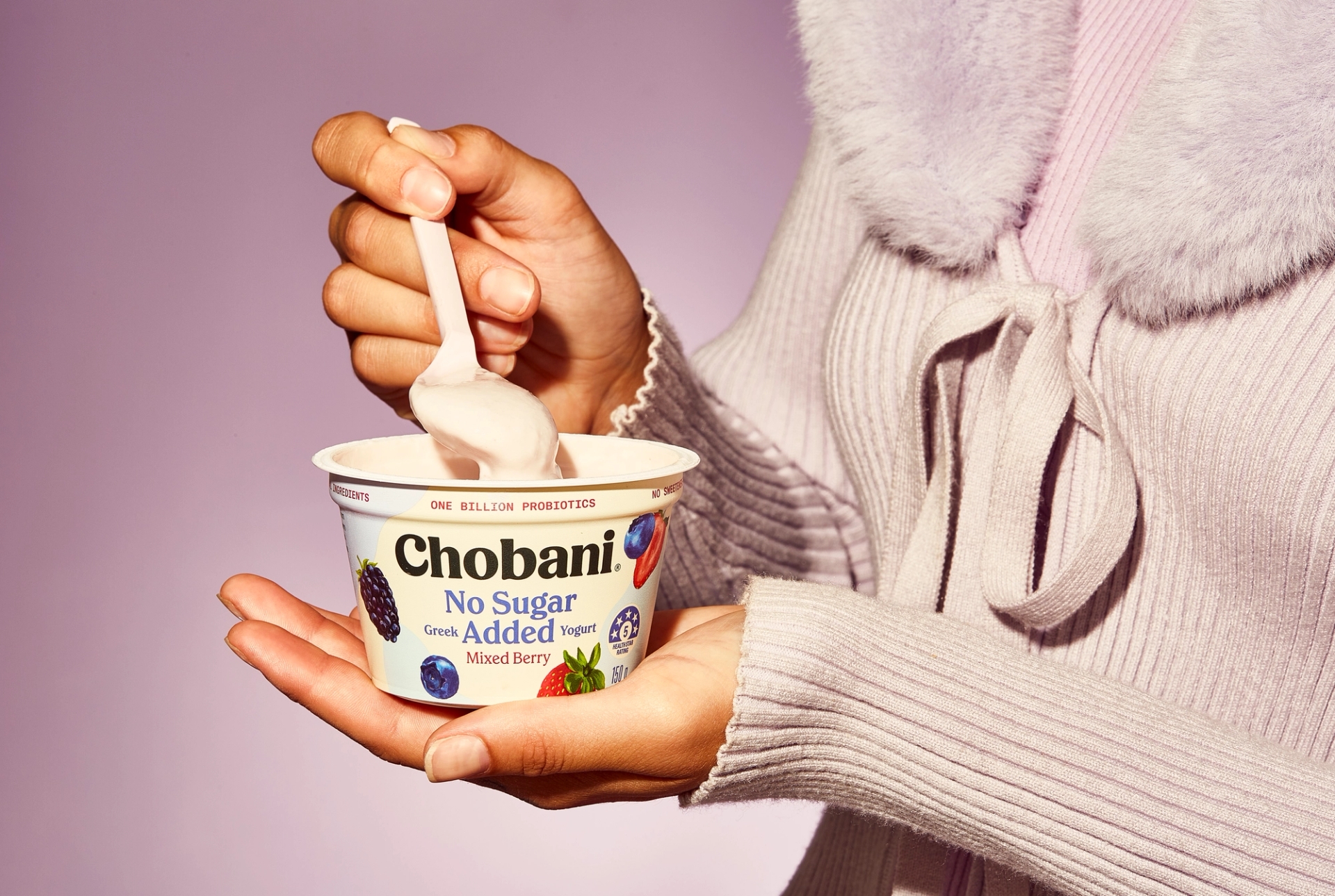 Nineties style photography of a person eating Chobani No Sugar Added yogurt featuring packaging design agency by Our Revolution