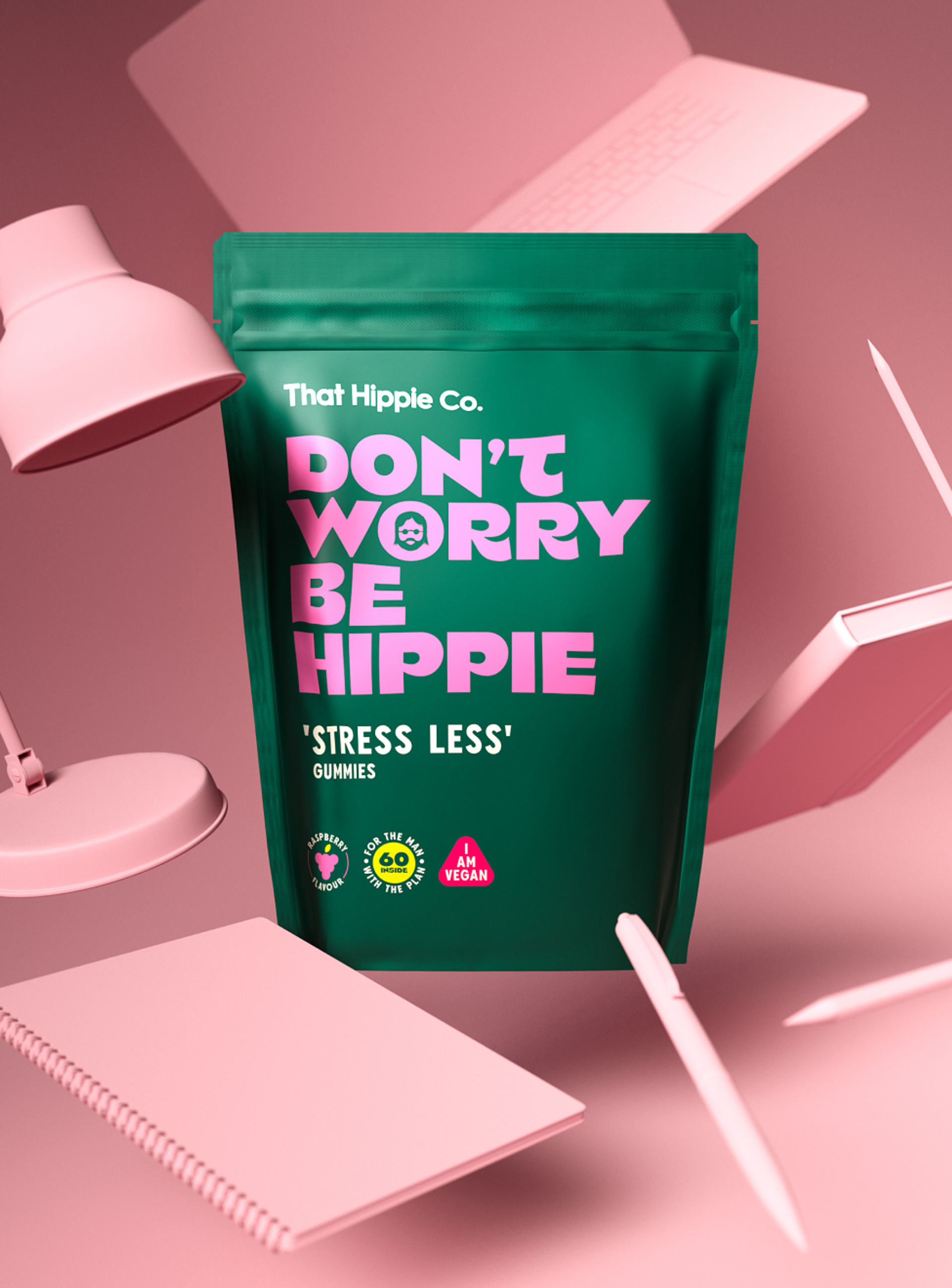 Gummies packaging design by branding agency in Australia Our Revolution for That Hippie Co supplement brand with pastel pink office accessories for vegan “Stress Less” gummies featuring brand slogan “Don’t worry be hippie”.
