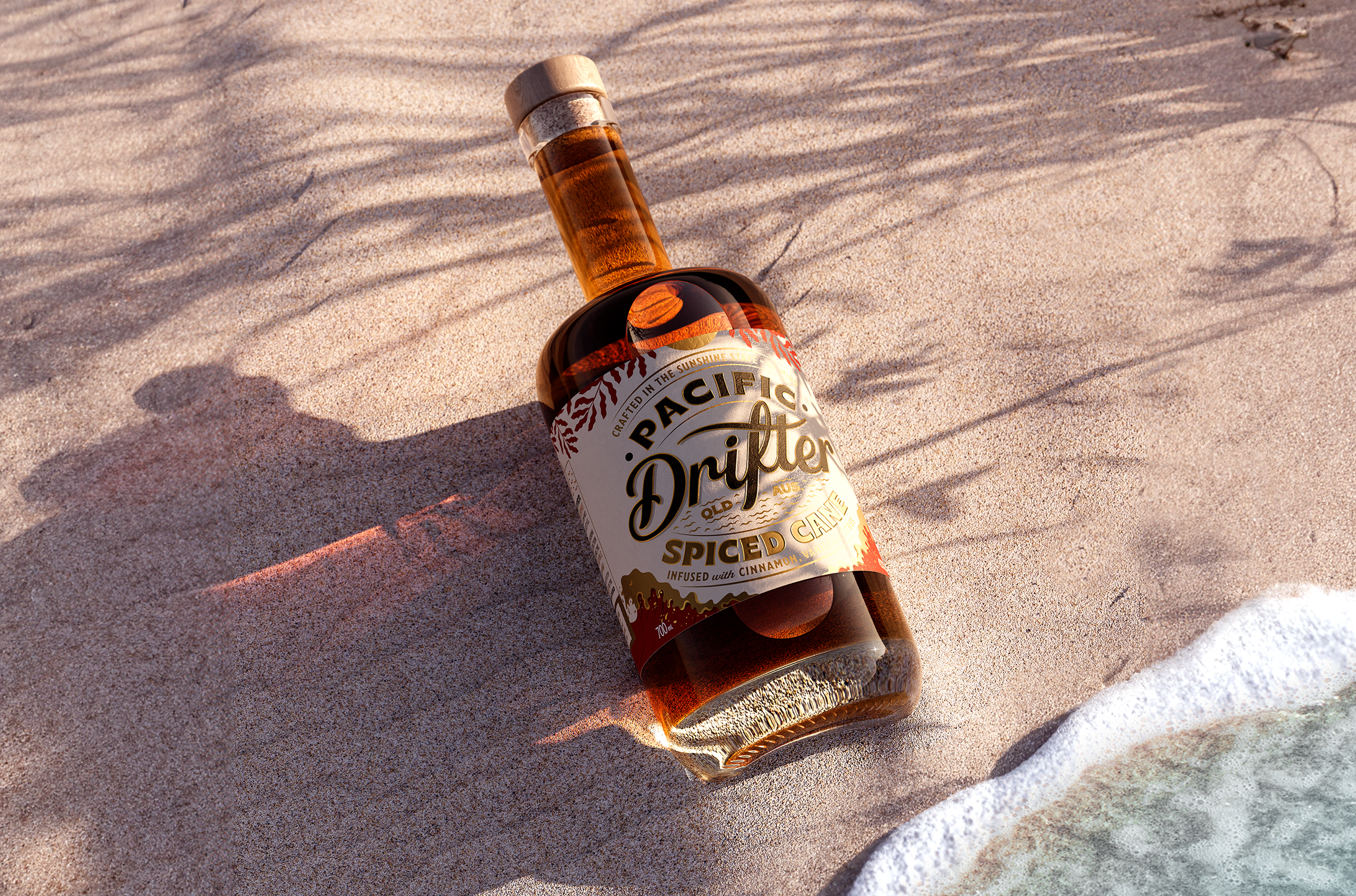 Packaging design of a bottle of rum lying in the sand with brand and packaging design by agency Our Revolution design agency in Sydney and London
