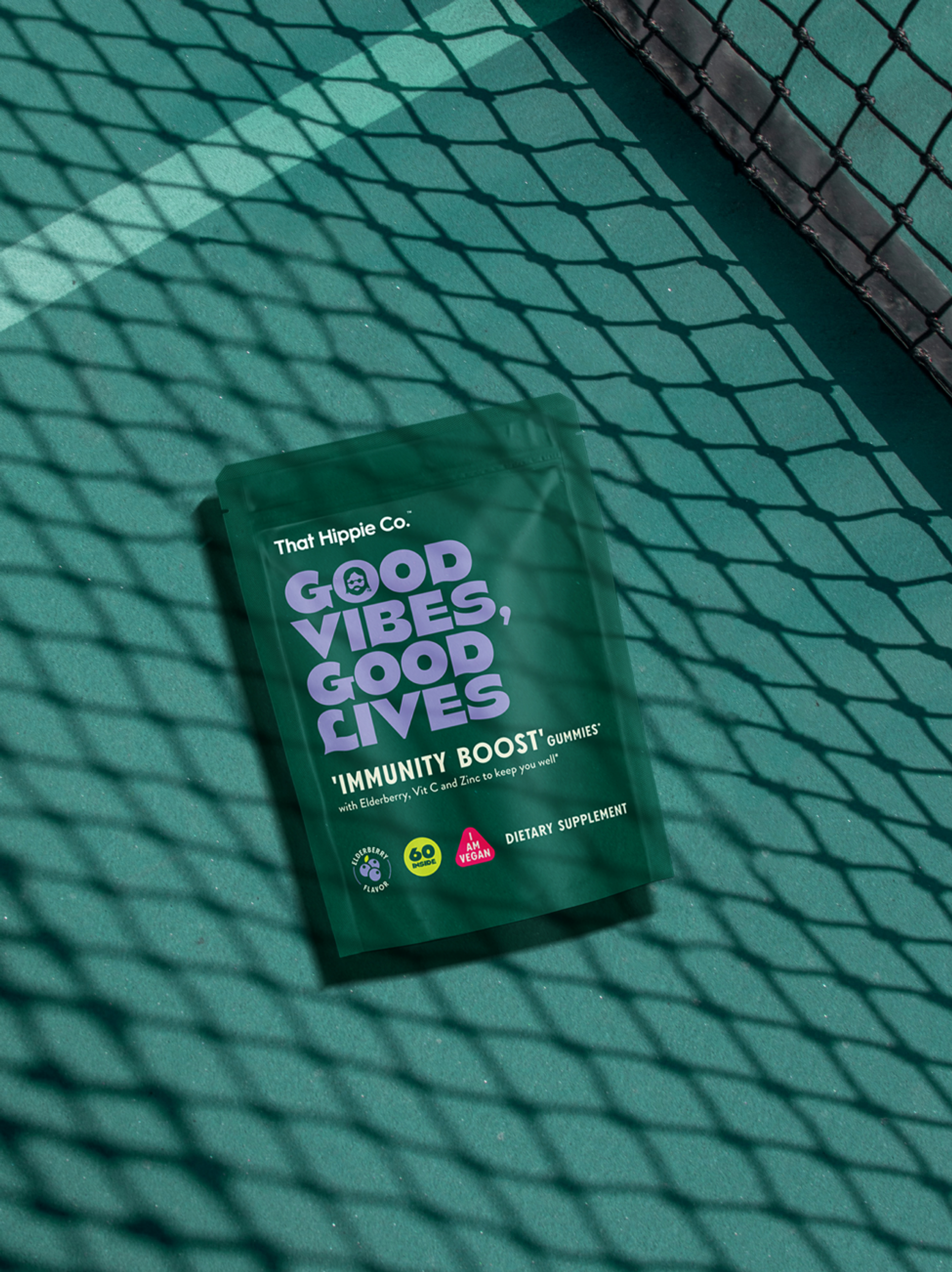 “Good vibes, good lives” immunity boost gummies by packaging design agency Our Revolution for supplement brand That Hippie Co. in the shadow of tennis court net
