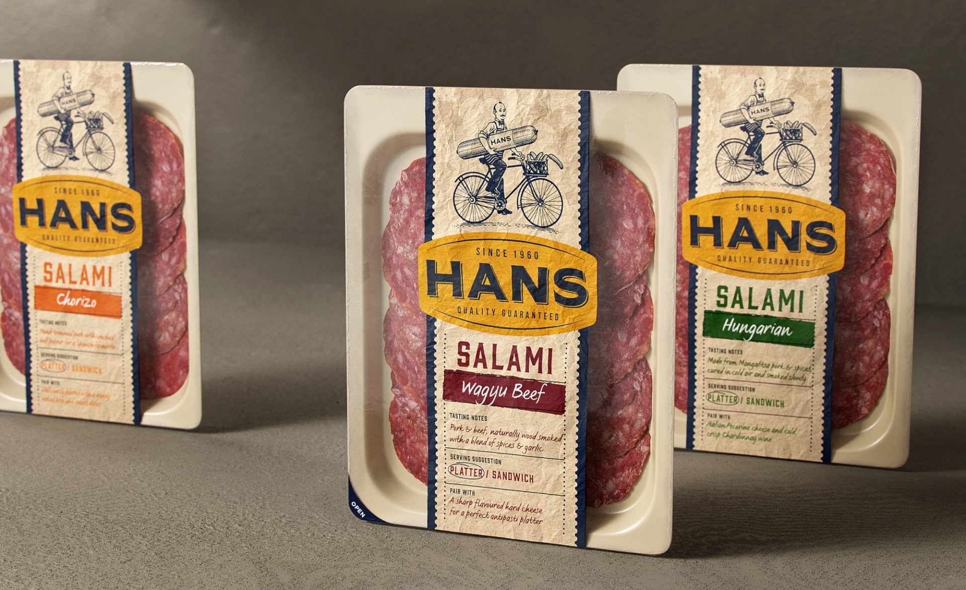Cool meat packaging design by Our Revolution for meat brand Hans Chorizo, Wagyu Beef, and Hungarian Salami on textured neutral background